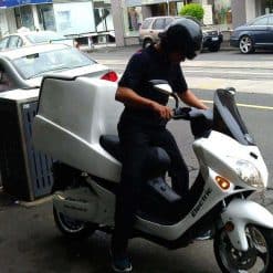 Man On Electric Motorbike With Cargo Box